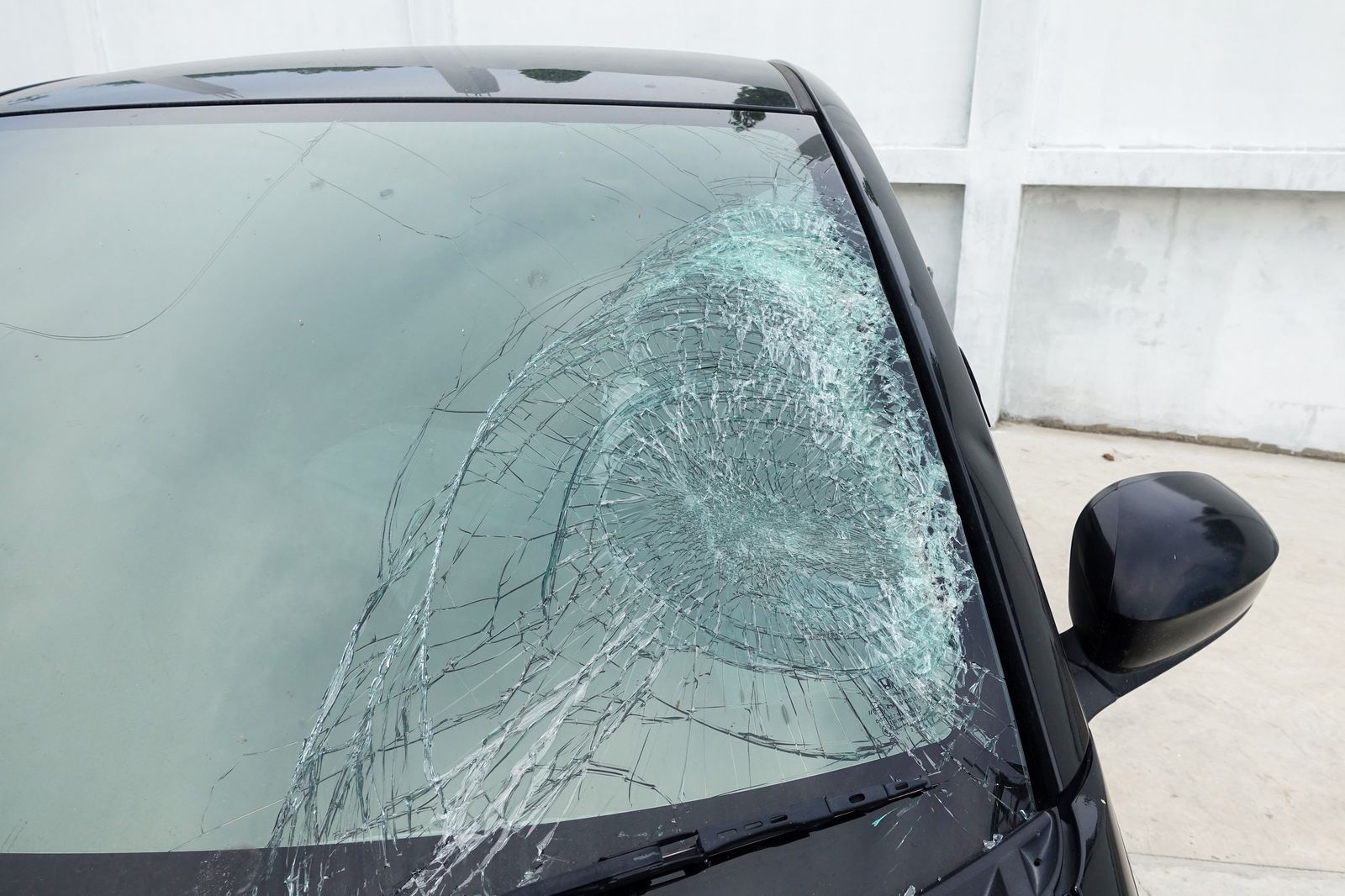 Large spreading windshield crack from an untreated rock chip on a car in Laurel, MD